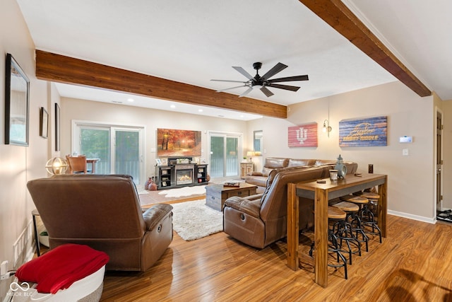 living room featuring beam ceiling, ceiling fan, and light hardwood / wood-style flooring