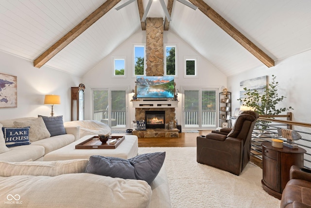 7701 Center Lake Rd, Nineveh, IN 46164 - living room featuring high vaulted ceiling, a stone fireplace, wood finished floors, and a wood ceiling with exposed beams