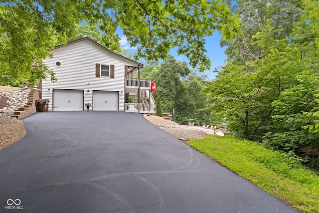 view of home's exterior with a garage and a deck