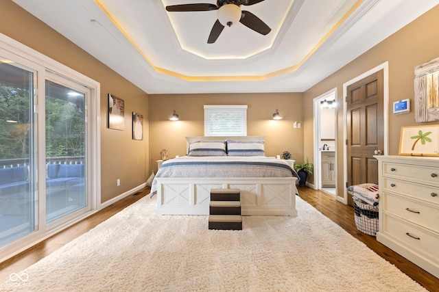 bedroom with access to outside, a raised ceiling, ceiling fan, and hardwood / wood-style flooring