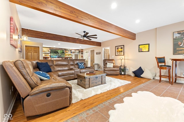 living room featuring beam ceiling, ceiling fan, and hardwood / wood-style flooring