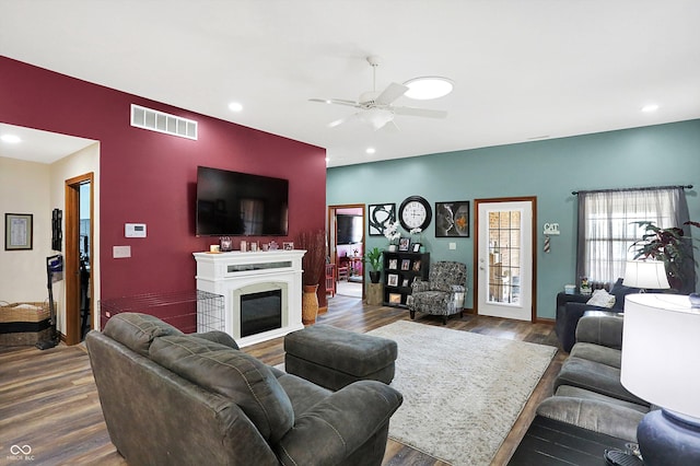 living room with dark hardwood / wood-style floors and ceiling fan