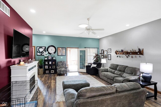 living room featuring dark hardwood / wood-style floors and ceiling fan