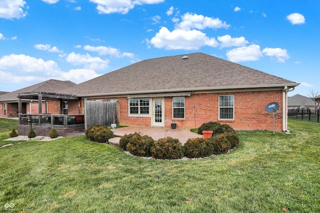 rear view of house featuring a lawn and a patio area