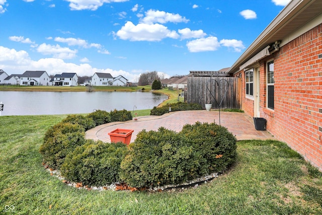 view of yard with a patio area and a water view