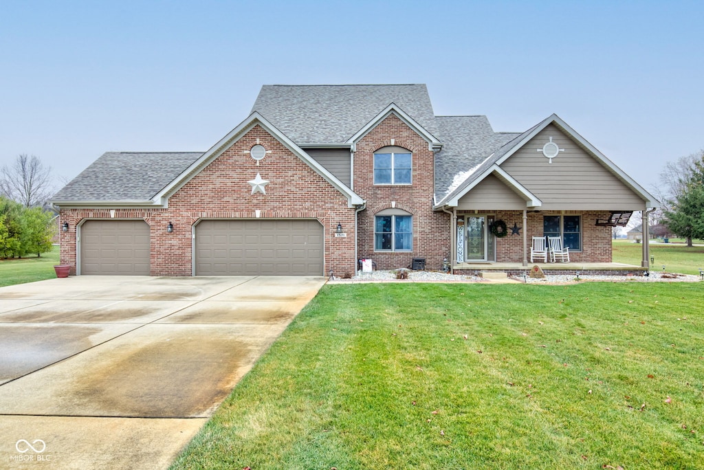 view of front of house with a porch, a garage, and a front yard