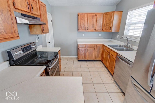 kitchen with sink, light tile patterned floors, a textured ceiling, and appliances with stainless steel finishes