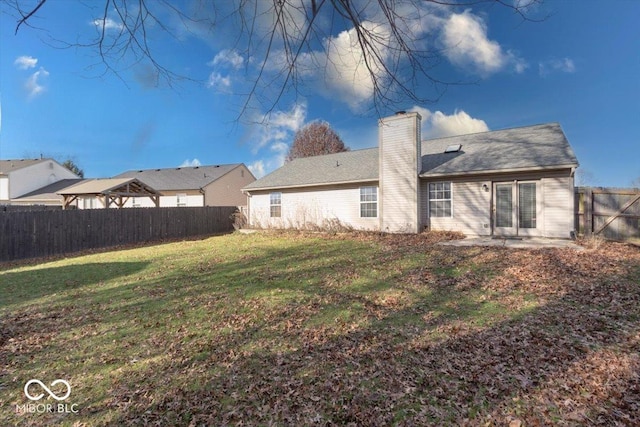 rear view of house with a yard