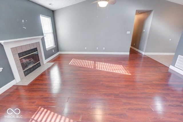 unfurnished living room with wood-type flooring and vaulted ceiling