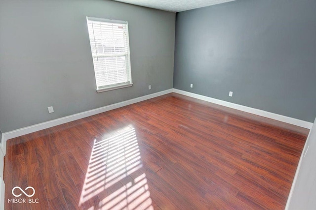 spare room with hardwood / wood-style flooring