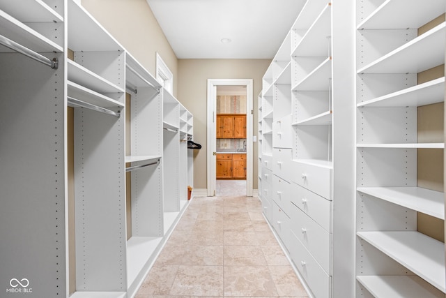 spacious closet with light tile patterned flooring