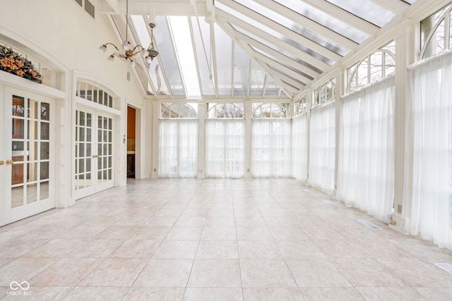 unfurnished sunroom with lofted ceiling with beams and an inviting chandelier