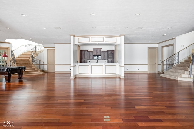 living room featuring hardwood / wood-style flooring, ornamental molding, and pool table