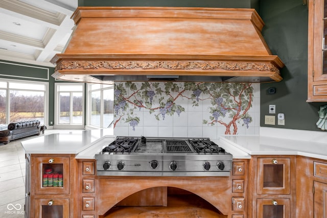 kitchen featuring decorative backsplash, coffered ceiling, stainless steel gas cooktop, crown molding, and beamed ceiling