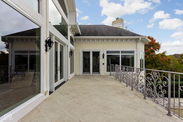 view of patio with a balcony and french doors