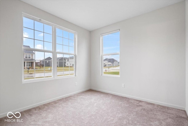 unfurnished room featuring light colored carpet