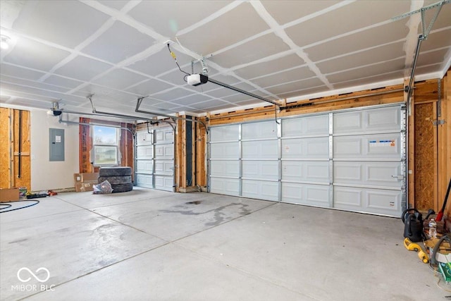 garage with a garage door opener and electric panel