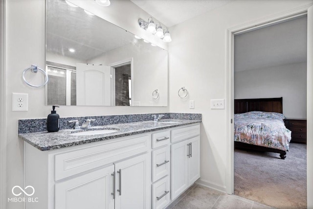 bathroom with tile patterned floors, vanity, and walk in shower