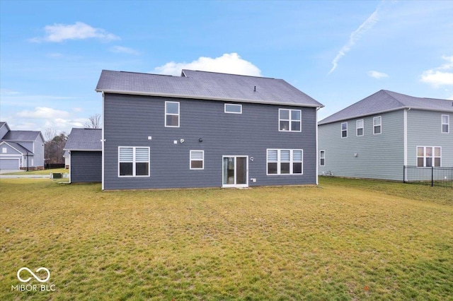 back of house featuring a yard