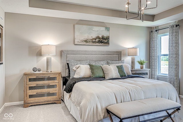 bedroom featuring light carpet, a chandelier, and baseboards