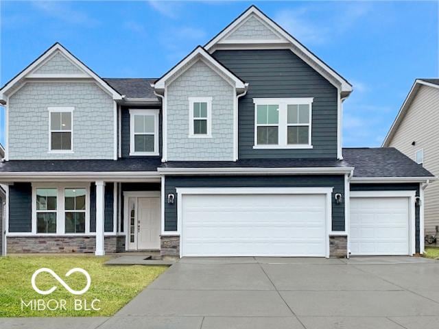 view of front of property with stone siding, a front lawn, and driveway