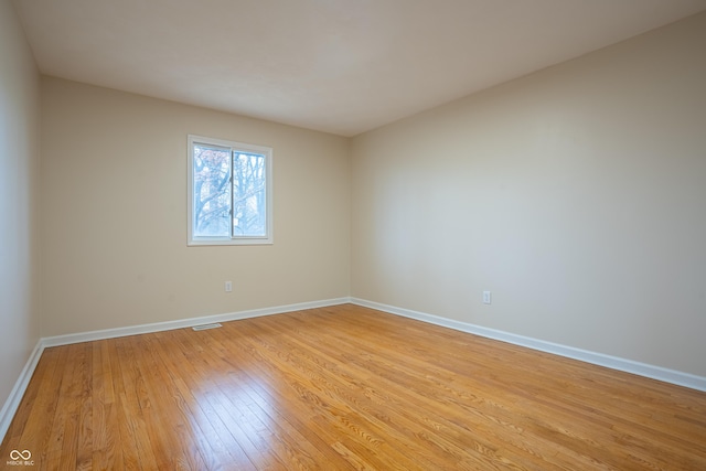 empty room with light hardwood / wood-style flooring