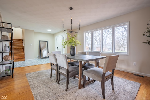 dining area featuring a chandelier and light hardwood / wood-style flooring