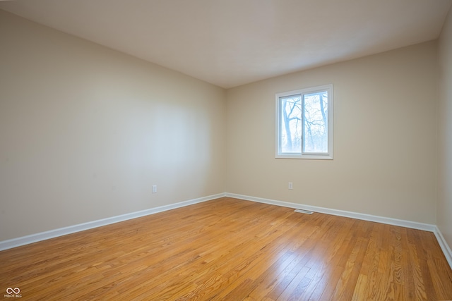 spare room with light hardwood / wood-style floors