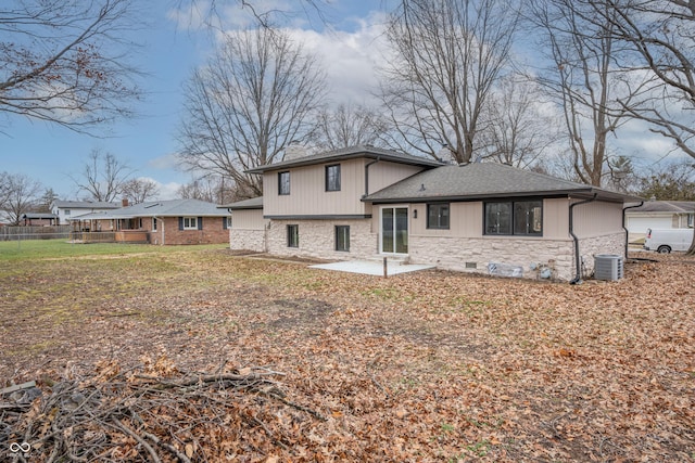 rear view of house with a yard, a patio, and central AC