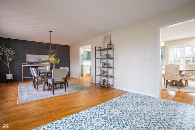 dining area featuring a chandelier and light hardwood / wood-style flooring