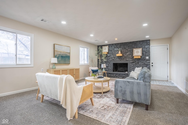 carpeted living room with a fireplace