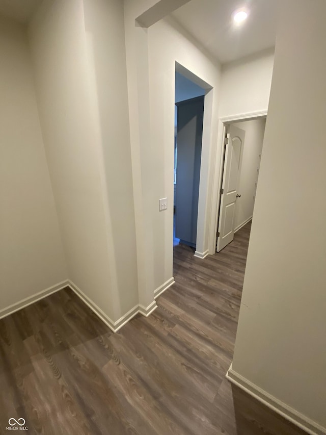 corridor with dark hardwood / wood-style floors