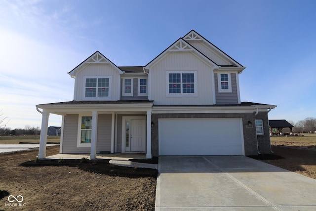 view of front of property with a porch and a garage