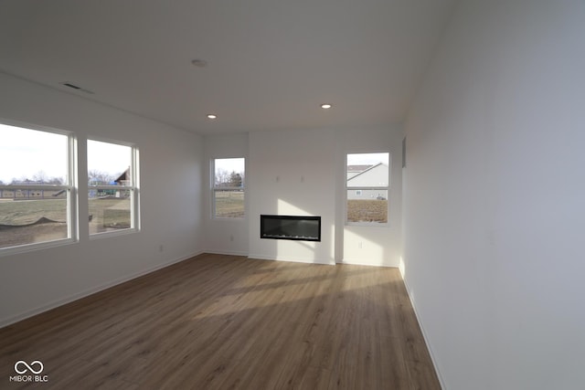 unfurnished living room featuring wood-type flooring