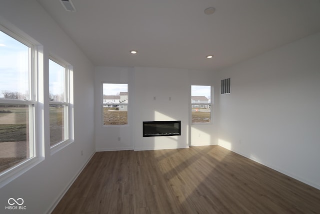 unfurnished living room featuring dark hardwood / wood-style flooring