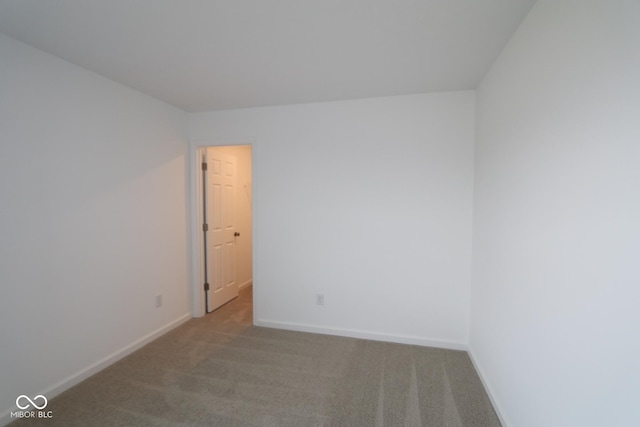 unfurnished room with light carpet