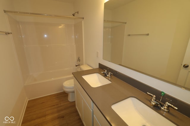 full bathroom featuring vanity, wood-type flooring, toilet, and shower / bath combination