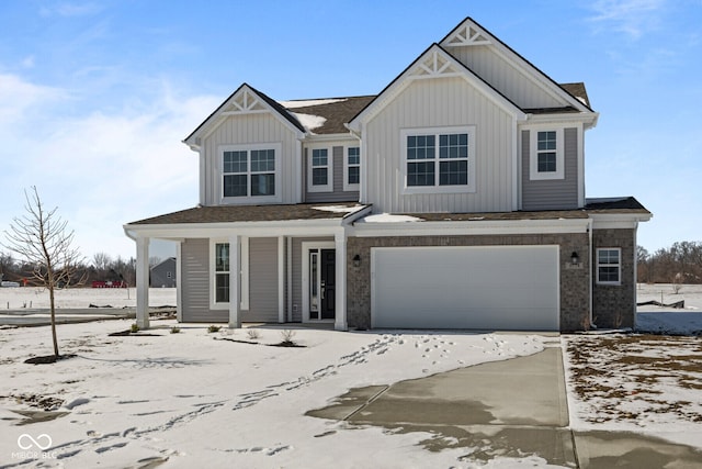 view of front of house with board and batten siding, covered porch, driveway, and a garage