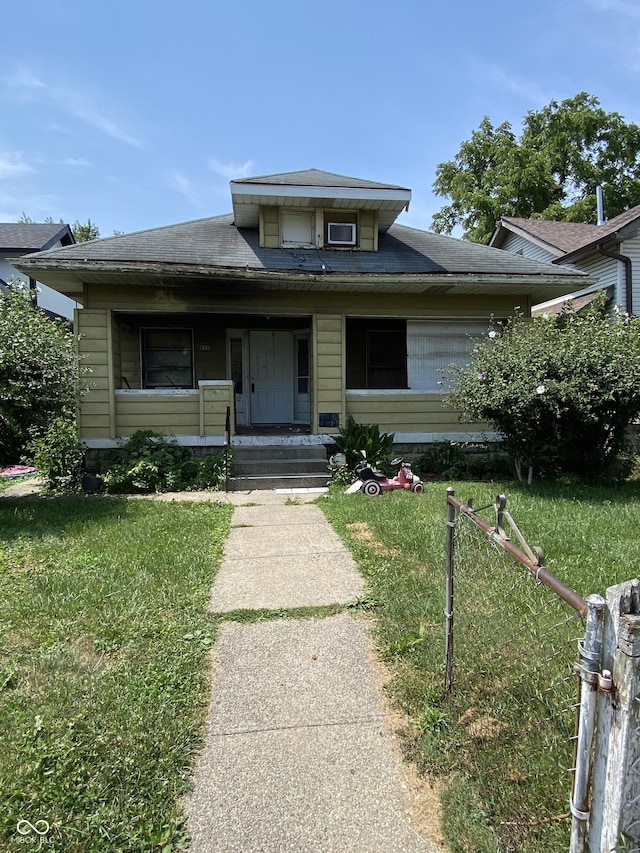 view of front facade with covered porch and a front yard