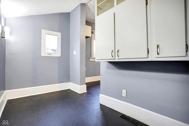 interior space featuring dark hardwood / wood-style flooring and lofted ceiling