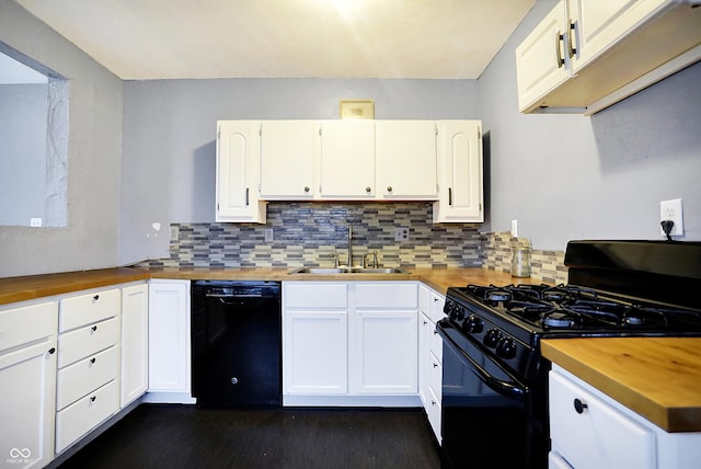 kitchen with white cabinetry, sink, black appliances, and wood counters