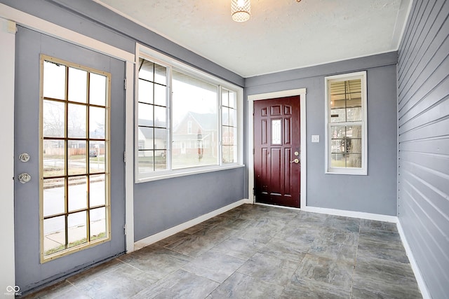 doorway featuring a healthy amount of sunlight and a textured ceiling