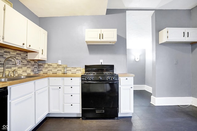 kitchen with decorative backsplash, white cabinetry, sink, and black appliances