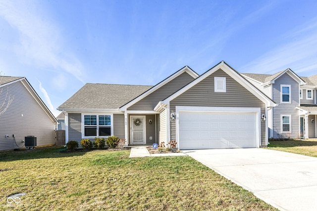 view of front facade featuring a front yard, a garage, and central air condition unit