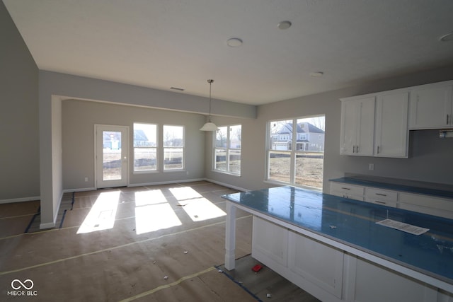 kitchen featuring white cabinetry and decorative light fixtures