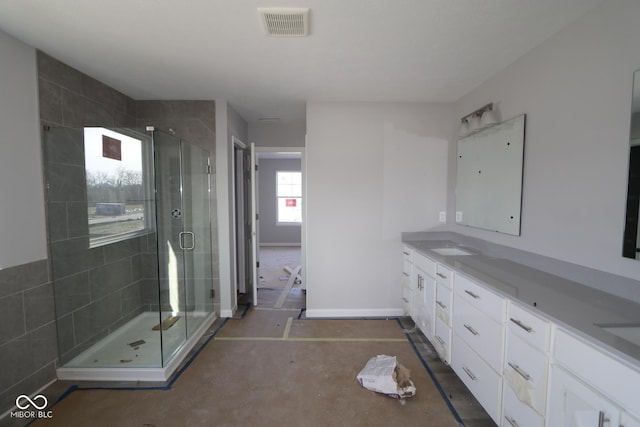 bathroom with vanity and a shower with shower door