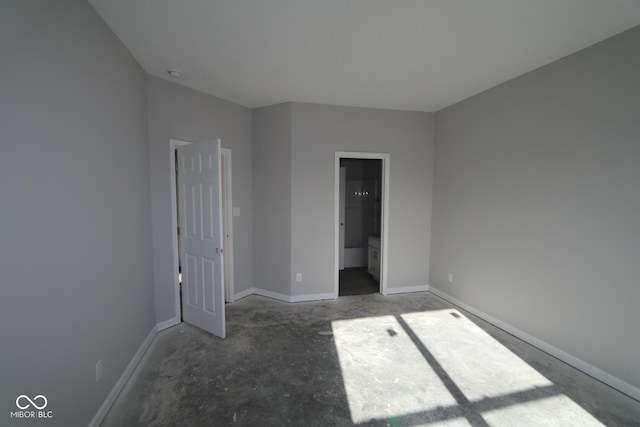 unfurnished bedroom featuring concrete flooring