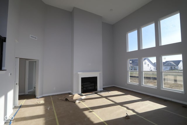 unfurnished living room with a high ceiling