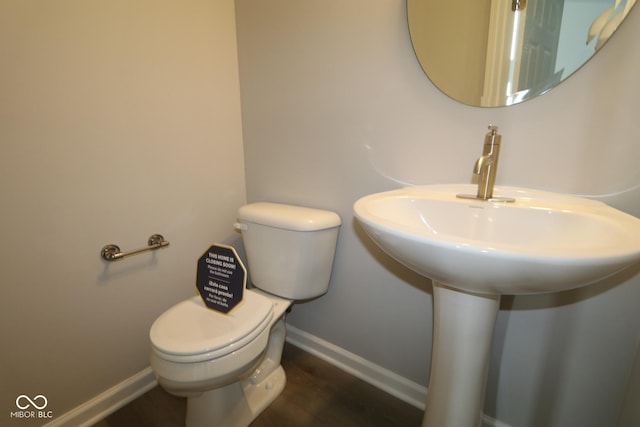 bathroom featuring sink, toilet, and hardwood / wood-style floors