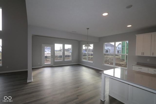 unfurnished dining area with dark wood-type flooring and a chandelier